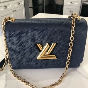 Luxurious Louis Vuitton Navy Crossbody Bag with Gold Chain and hand mirror.